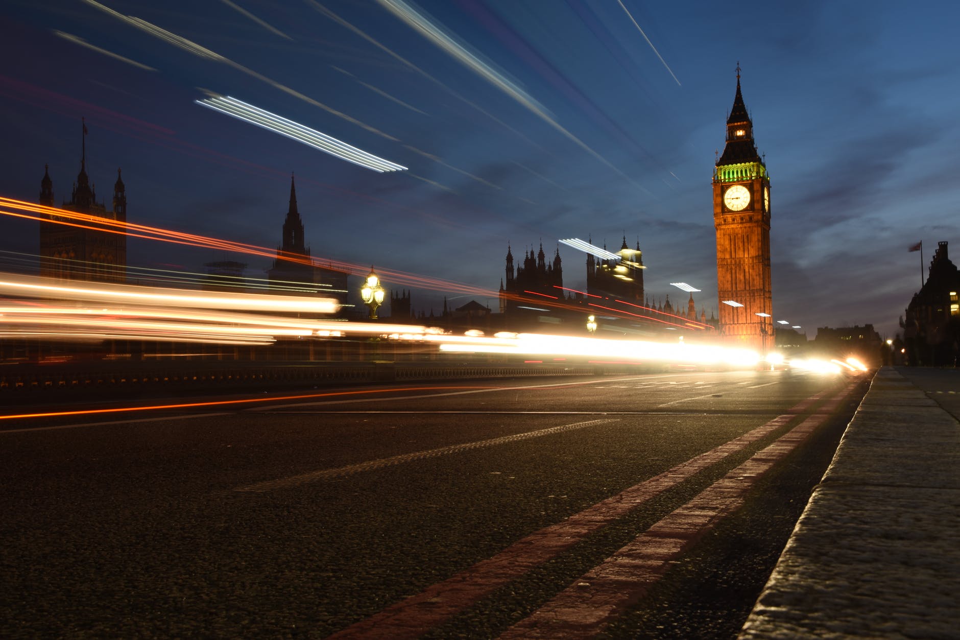 time lapse photography of vehicles passing near building