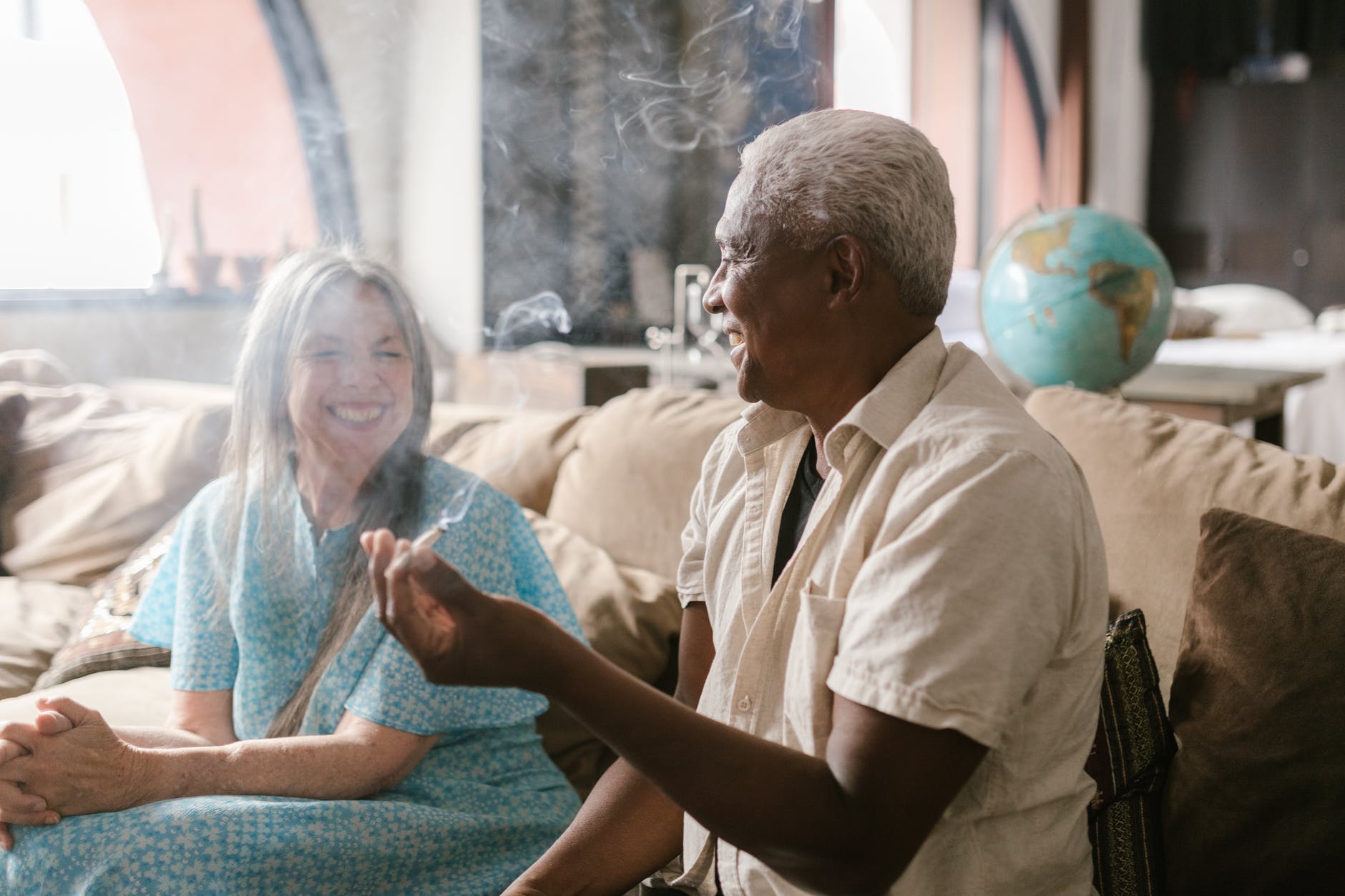 elderly man holding spliff